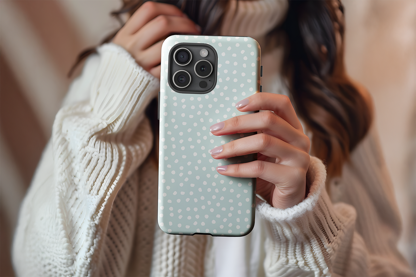 A cute girl holding our Aqua Dots design phone case