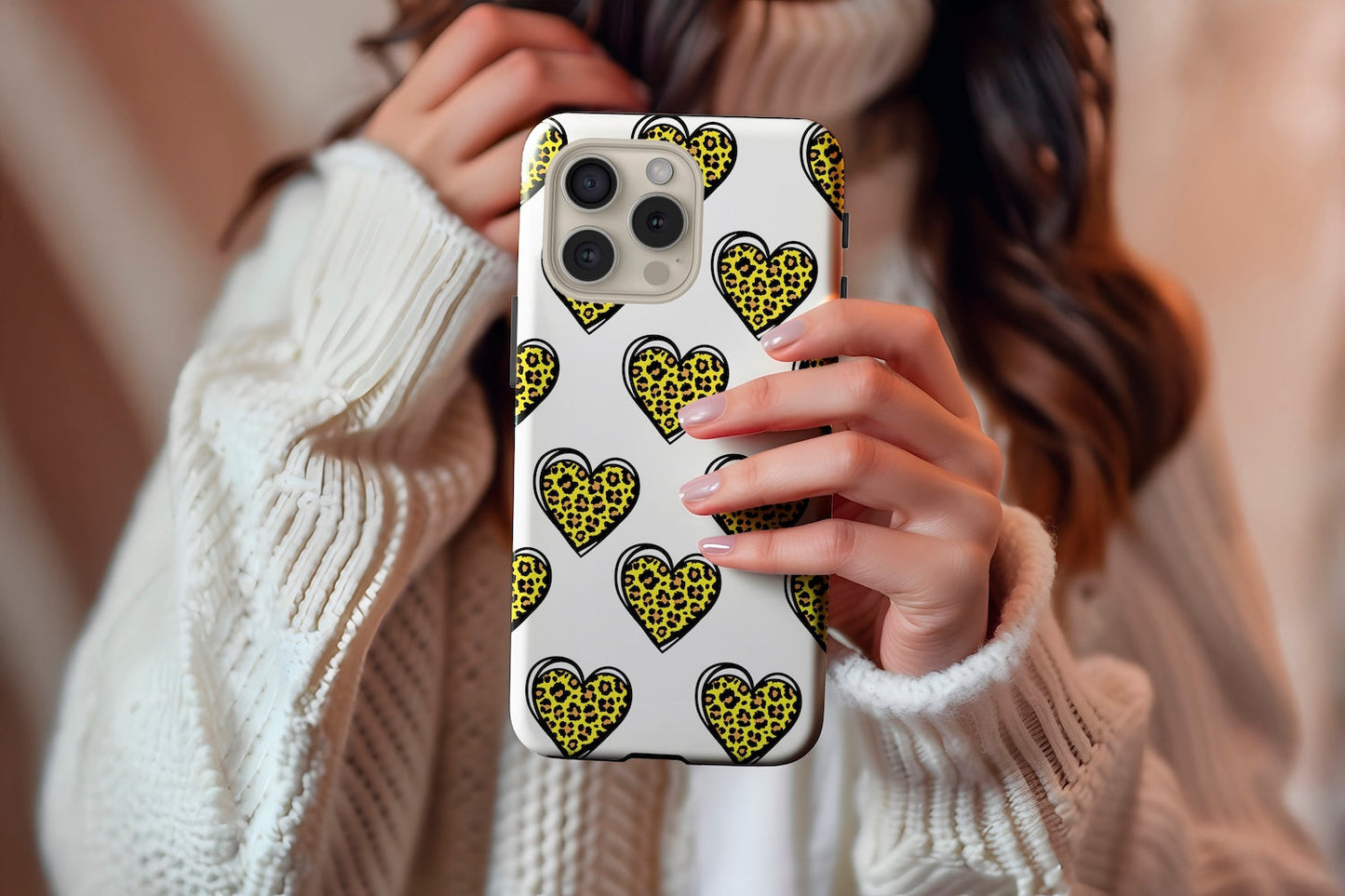 A cute girl holding our Leopard Hearts design phone case