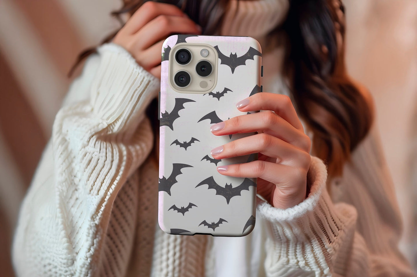 A cute girl holding our Watercolour Bats design phone case